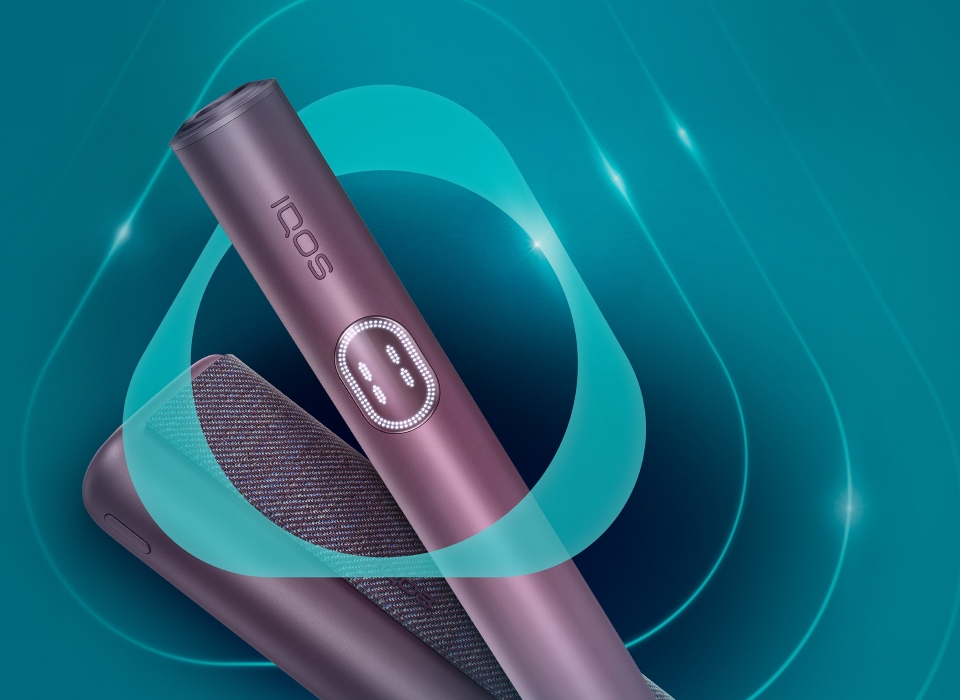 Garnet Red IQOS ILUMA i PRIME device and its charger, inside the IQOS logo