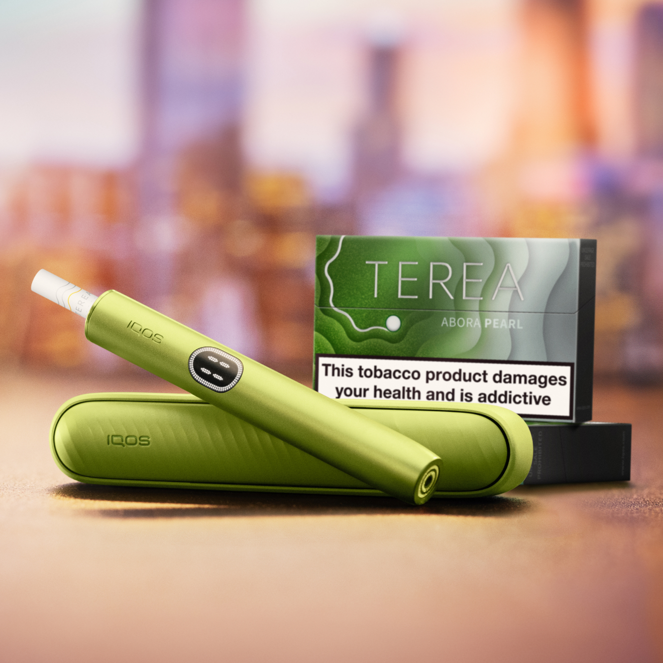 Green IQOS ILUMA i device with a package of TEREA sticks